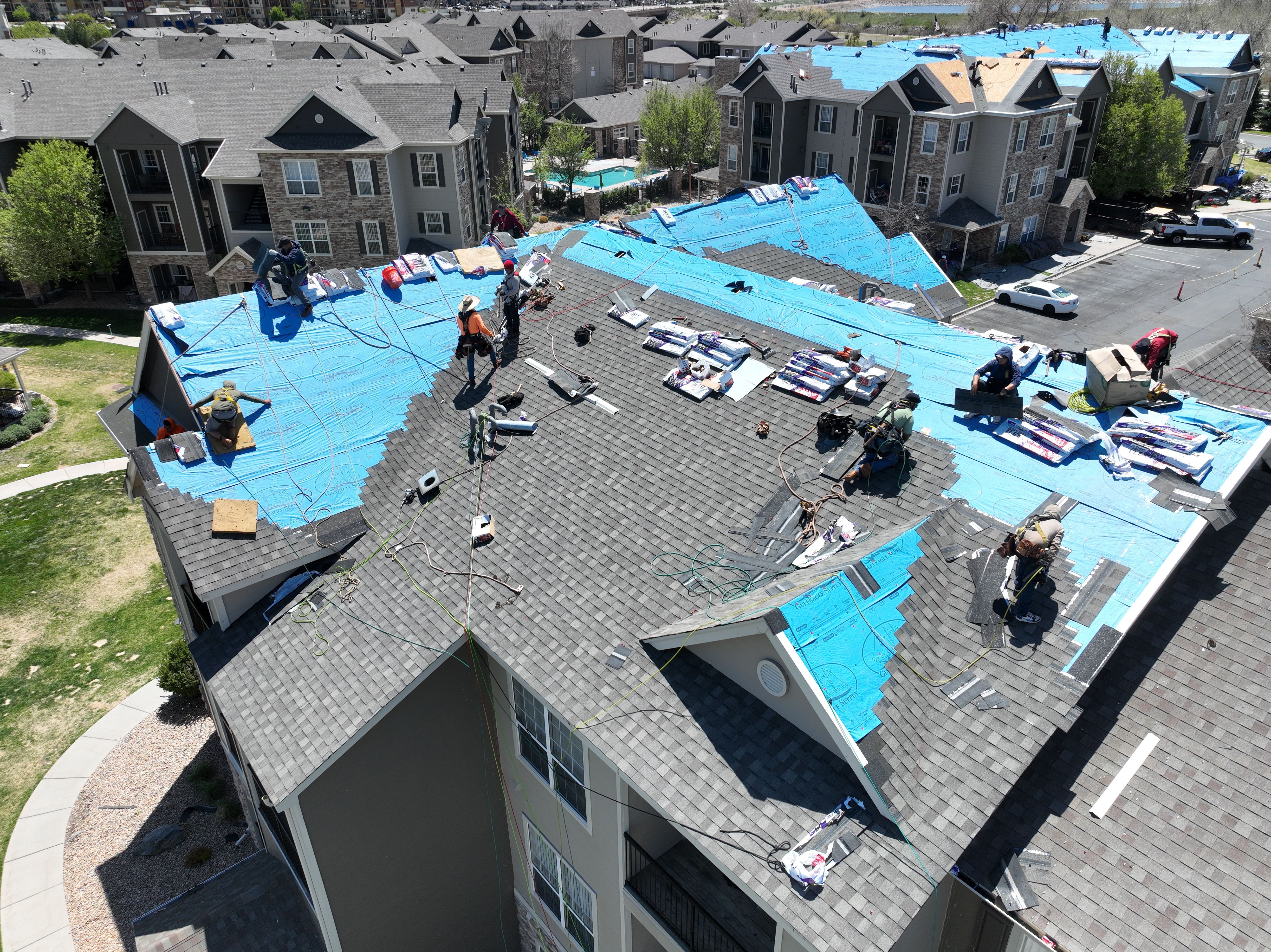 Aerial of Force 5 Roofing crew replacing an entire multifamily apartment complex roof after hail damage