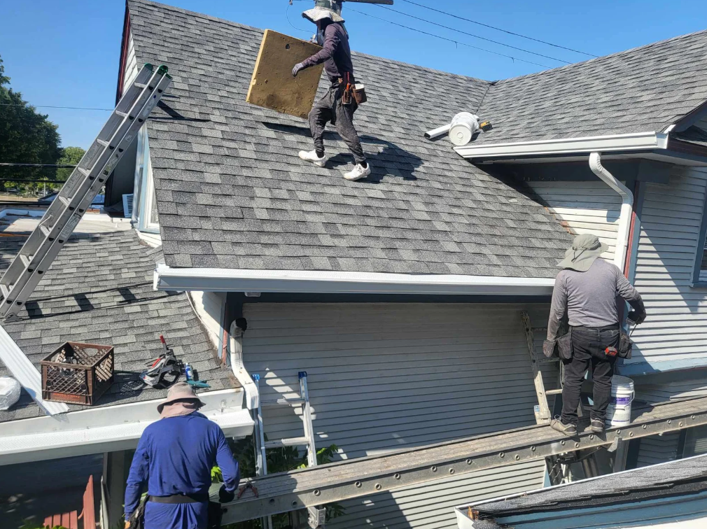 Force 5 Roofing crew installing seamless gutters on a residential home