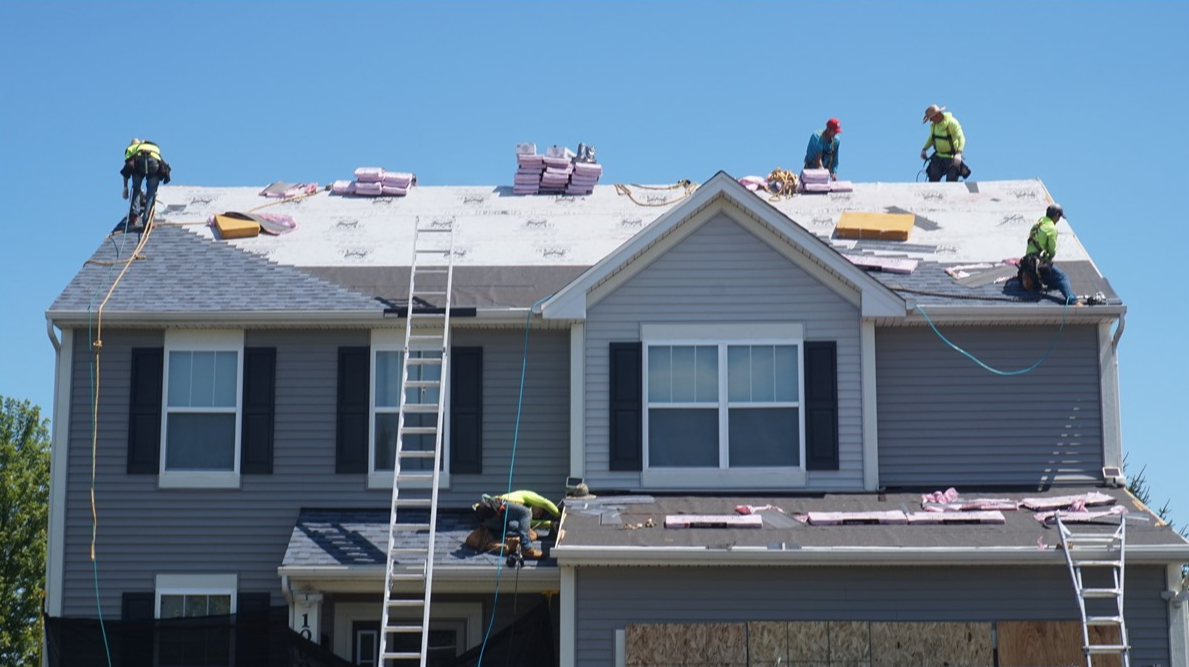 Force 5 Roofing crew installing a new roof on a two-story Aurora home after hail damage